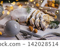Holiday Stollen with Almonds on Wooden Board 142028514