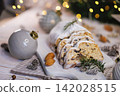 Sliced Christmas Stollen with Pine Decor and Ornaments 142028515
