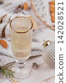 Holiday champagne glass with stollen and festive ornaments 142028521