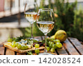 Garden Wine Tasting with White Wine, Grapes, and Cheese Platter 142028524