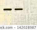 A minimalist architectural background featuring striking slit openings in exposed concrete walls. 142028987
