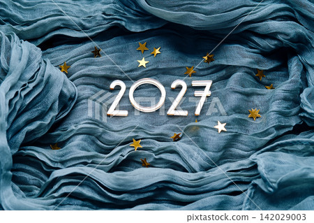 New Year's background with the number 2027 on a blue background. New Year's background with the number 2027 on a blue background. 142029003