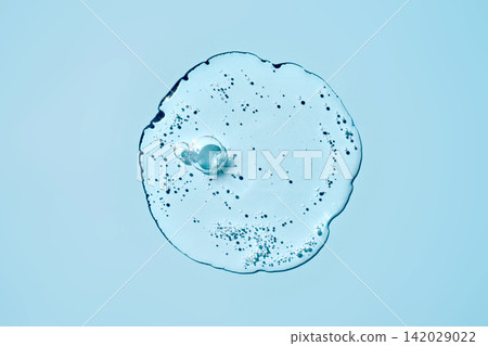 Cosmetics serum liquid gel texture on blue background 142029022