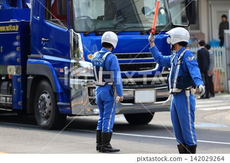 Image of a police officer directing traffic. Image of a police officer directing traffic. 142029264