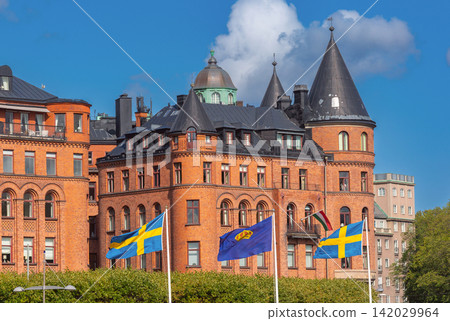 Historic Brick Architecture with Swedish Flags in Stockholm, Sweden Historic Brick Architecture with Swedish Flags in Stockholm, Sweden 142029964