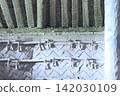 The interior of the reconstructed dwelling, featuring woven wooden walls and rope decorations, is a remnant of ancient architecture. 142030109