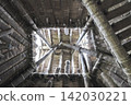 The ancient architectural structure of a pit dwelling, with its wooden framework and ropes in the attic. 142030221