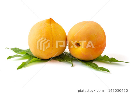 fresh Yellow Peach Fruit With Leaves Close Up fresh Yellow Peach Fruit With Leaves Close Up 142030430