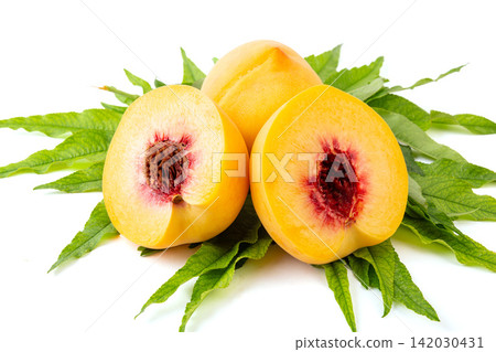 fresh Yellow Peach Fruit With Leaves Close Up fresh Yellow Peach Fruit With Leaves Close Up 142030431