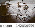 The texture of the woven wooden walls and wood in the reconstructed dwelling, where rope decorations remain. 142030559