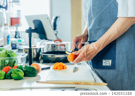 A young man cooking A young man cooking 142031188