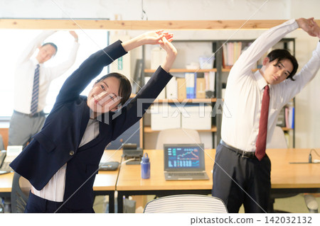 Business people stretching during work breaks Business people stretching during work breaks 142032132