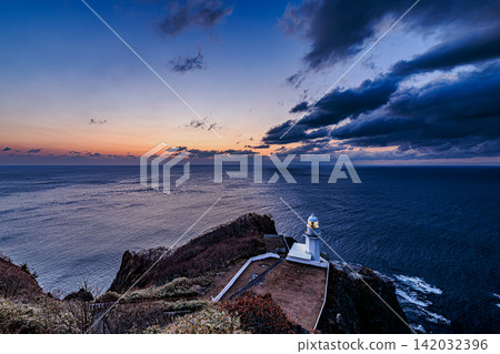The dramatic sunrise clouds and the vast expanse of the ocean create a beautiful scene at dawn in Cape Chikyu, Muroran. The dramatic sunrise clouds and the vast expanse of the ocean create a beautiful scene at dawn in Cape Chikyu, Muroran. 142032396