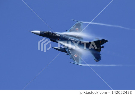 A Japan Air Self-Defense Force F-2 fighter jet turns while emitting vapor trails. A Japan Air Self-Defense Force F-2 fighter jet turns while emitting vapor trails. 142032458