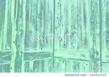 Greenish old wooden door with wood grain texture and nail holes. Greenish old wooden door with wood grain texture and nail holes. 142032575