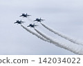 Four Blue Impulse aircraft fly in formation against a gray sky. 142034022