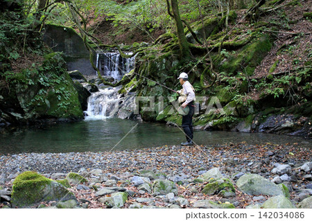 A fisherman fishing in the Kurosakaishi River, a tributary of the Watarase River. A fisherman fishing in the Kurosakaishi River, a tributary of the Watarase River. 142034086
