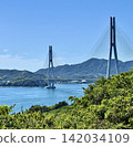 A clear, sunny day overlooking the Shimanami Kaido, the Tatara Bridge, and the lush green islands. 142034109