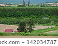 A house with a red roof and a train on the Furano Line 142034787
