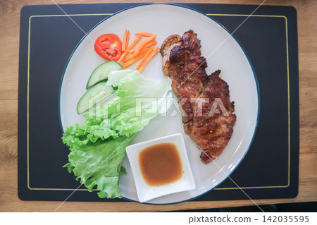 pork steak or grilled pork and salad or pork chop and vegetable pork steak or grilled pork and salad or pork chop and vegetable 142035595