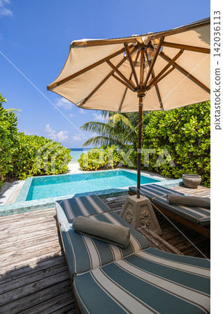 Serene private pool daybed lush palms beside calm azure water secluded tropical resort villa. Luxury travel resort paradise scenic. Exotic honeymoon getaway wallpaper art Serene private pool daybed lush palms beside calm azure water secluded tropical resort villa. Luxury travel resort paradise scenic. Exotic honeymoon getaway wallpaper art 142036113