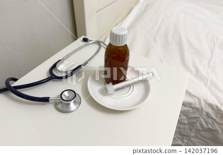 stethoscope and medicine on a table stethoscope and medicine on a table 142037196