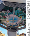 A vibrant peacock and seasonal flowers are depicted in the ceiling mural of the shopping arcade. 142037364