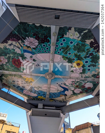 A vibrant peacock and seasonal flowers are depicted in the ceiling mural of the shopping arcade. A vibrant peacock and seasonal flowers are depicted in the ceiling mural of the shopping arcade. 142037364