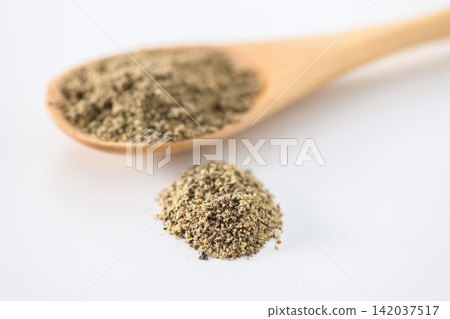 Ground black pepper powder served in a wooden spoon Ground black pepper powder served in a wooden spoon 142037517