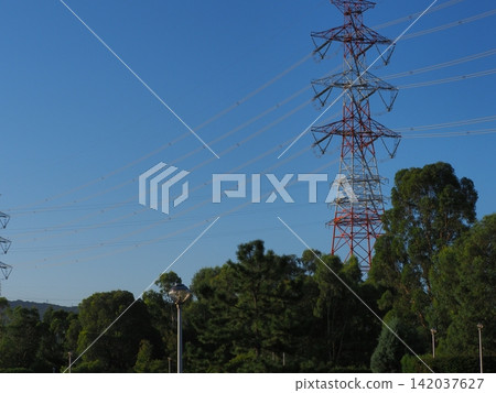 Power transmission towers and high-voltage power lines soaring into the blue sky. Power transmission towers and high-voltage power lines soaring into the blue sky. 142037627