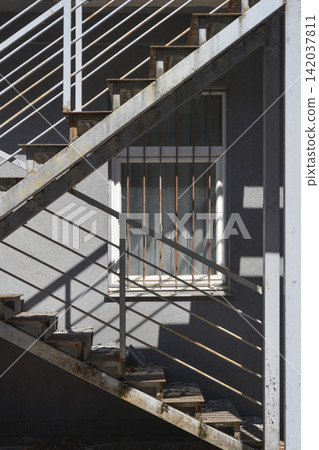 External metal emergency staircase on a building facade External metal emergency staircase on a building facade 142037811