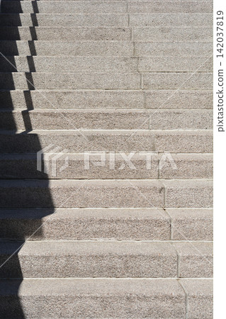 Granite stairs with railing shadow close up Granite stairs with railing shadow close up 142037819
