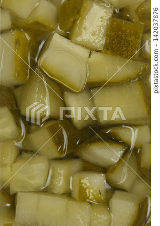 Chopped pickled cucumbers in brine close up Chopped pickled cucumbers in brine close up 142037876