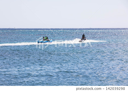 Enjoy marine activities such as banana boating and jet skiing across Okinawa's blue ocean. Enjoy marine activities such as banana boating and jet skiing across Okinawa's blue ocean. 142039298