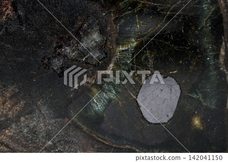 Macro Diopside mineral stone on black background Macro Diopside mineral stone on black background 142041150