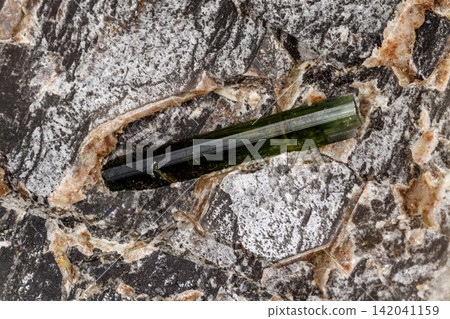 Macro stone tourmaline mineral on a black background Macro stone tourmaline mineral on a black background 142041159