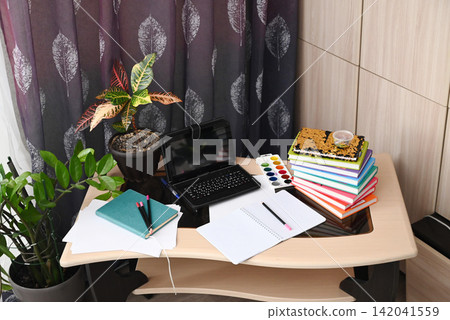 Modern empty freelancer or student work table with laptop, wireless headphones and documents in folders at home Modern empty freelancer or student work table with laptop, wireless headphones and documents in folders at home 142041559