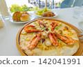 Lunch set with seafood pizza, bread, and hamburger steak at an ocean-view restaurant/cafe (Amami Oshima, Kagoshima Prefecture) 142041991