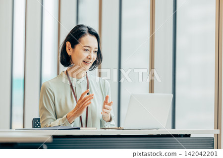 Business woman heading to PC at office Business woman heading to PC at office 142042201