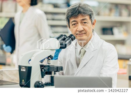 Researcher doing an experiment Researcher doing an experiment 142042227