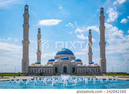 Nursultan mosque with four tall minarets and blue dome against blue sky in Astana Kazakhstan, Islamic landmark concept Nursultan mosque with four tall minarets and blue dome against blue sky in Astana Kazakhstan, Islamic landmark concept 142042380
