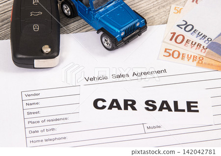 Blue toy car, key, euro banknotes and vehicle sales agreement. Blue toy car, key, euro banknotes and vehicle sales agreement. 142042781
