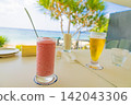 Toast with beer and cocktails at a beachside ocean-view restaurant/cafe bar - Resort (Amami Oshima, Kagoshima Prefecture) 142043306