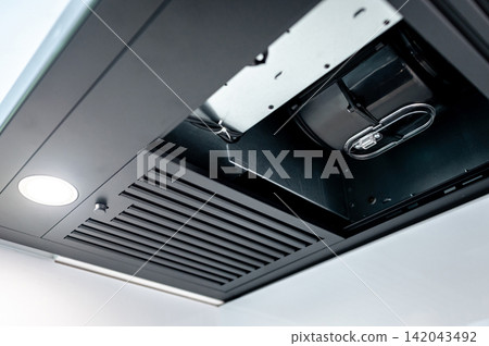 Extractor motor inside modern black cooker hood Extractor motor inside modern black cooker hood 142043492