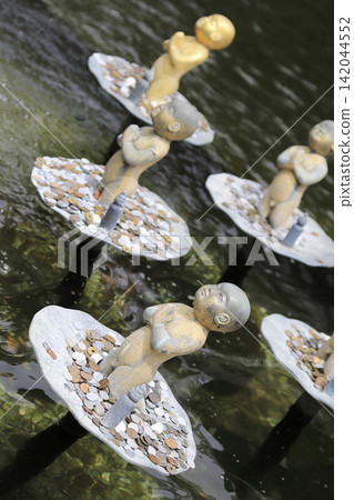 Children with their hands clasped together floating on the pond Children with their hands clasped together floating on the pond 142044552