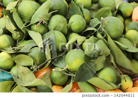 Green mandarin at fruit market Green mandarin at fruit market 142044811