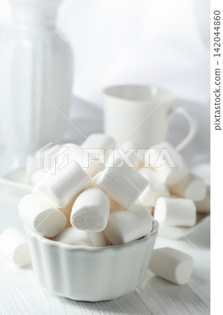 White marshmallows on a wooden table. White marshmallows on a wooden table. 142044860
