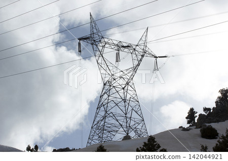 High voltage electricity pylon under snow landscape High voltage electricity pylon under snow landscape 142044921