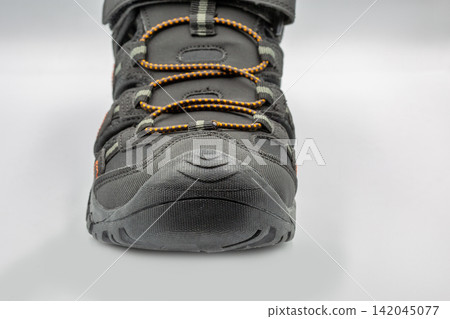 Mens black sporty trekking sandals active footwear closeup on white. Mens black sporty trekking sandals active footwear closeup on white. 142045077