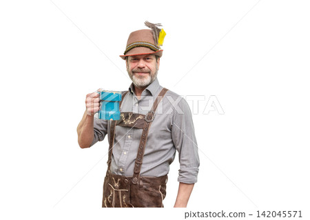 Smiling mature man in Bavarian outfit holding blue beer mug isolated Smiling mature man in Bavarian outfit holding blue beer mug isolated 142045571